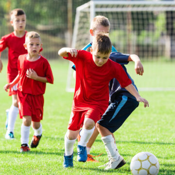 Boys kicking ball