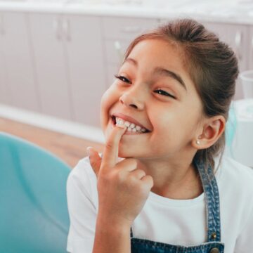 Young girl showing off her healthy smile during a pediatric dental visit